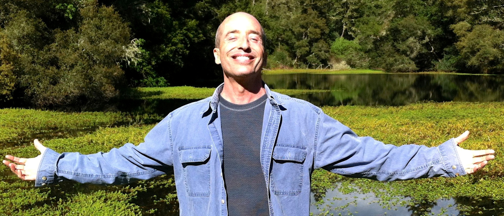 Terry Patten in bliss photo of Terry Patten with arms outstretched in nature